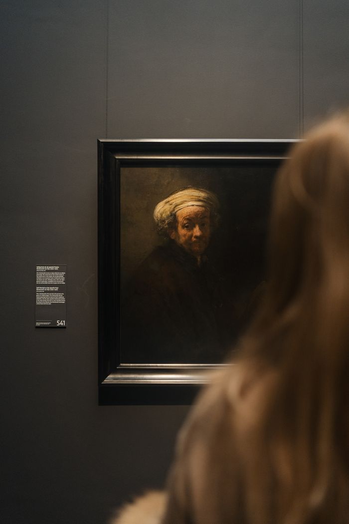 A woman admires a classic painting at the Rijksmuseum in Amsterdam, Netherlands.